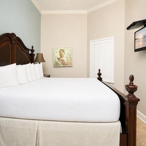 Sleep peacefully on a plush king bed in the guest room, watching your favorite shows on the wall-mounted TV