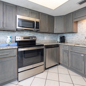 This modern kitchen features stainless appliances, granite countertops, and a Keurig coffee maker for your morning brew