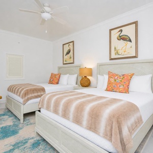 Fluffy throws invite cozy naps in the guest suite where nature-inspired art sets a peaceful tone