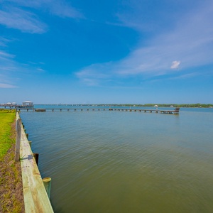 Relax in this lagoon side beach property with palm trees and easy access to the sandy shore just steps away from your stay