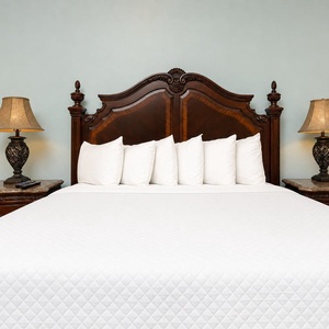 Drift into comfort on a plush king bed, enhanced by warm lighting and elegant decor, perfect for restful nights