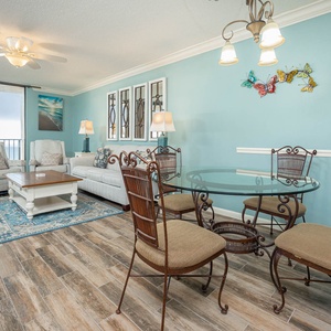 Relax in the airy living space, featuring comfortable seating, a stylish dining area, and vibrant coastal decor