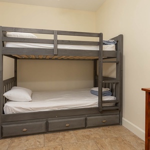Cozy bunk room with twin over twin beds, perfect for sharing stories and laughter with loved ones