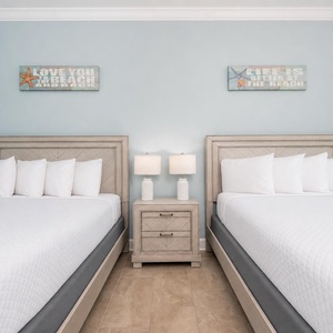 Cheerful bedroom featuring two queens, fluffy pillows, and relaxing vibe