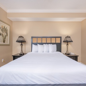 Drift into peaceful slumber in the queen bed in this guest suite, embraced by soft bedding and serene decor