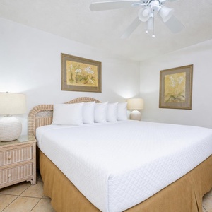 Light from bedside lamps calms the king suite where the cozy bed awaits your restful getaway