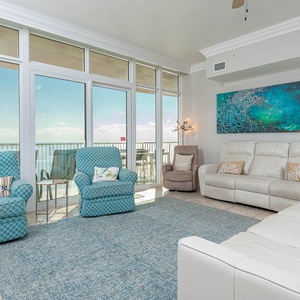 Relax in this inviting living area with plush seating, queen sofa sleeper, vibrant decor, and stunning views
