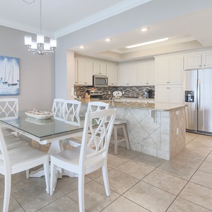 Gather around the stylish dining table, where laughter and conversation flow effortlessly in this inviting space