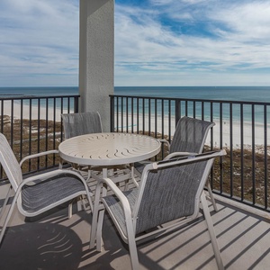 Balcony seating offers a relaxing spot to enjoy panoramic views of the tranquil gulf and white sand beach below