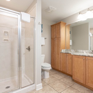 Refresh in this spacious guest bathroom featuring a walk-in shower, modern cabinetry, and ample counter space