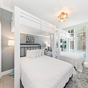 Relax in this charming bunk room with two cozy twins lofted above two plush queen beds