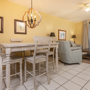 Enjoy meals at the charming dining table, surrounded by warm decor and a cozy living area with a comfortable sofa