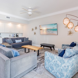 Relax in this gulf-themed living room with comfortable seating options and elegant lighting accents
