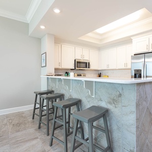 Savor your morning coffee in this inviting kitchen space with stainless appliances and stylish design