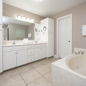 Refresh in the master bath after a day at the beach with a soothing jetted tub and relaxing walk-in shower