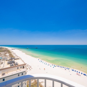 tunning views from your balcony, where you can soak in the vibrant colors of the water and beach below