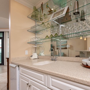 Create refreshing cocktails at your wet bar, surrounded by stylish glassware and inviting coastal decor