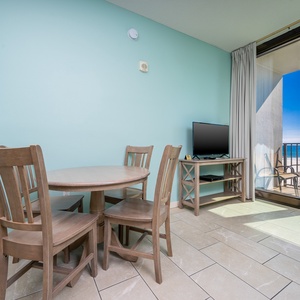 Dine at the round table, enjoy the view through sliding doors, and relax with a TV in this inviting space