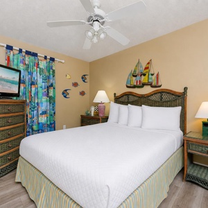 Drift into a peaceful sleep in this queen guest suite surrounded by charming coastal decor and soft, inviting bedding
