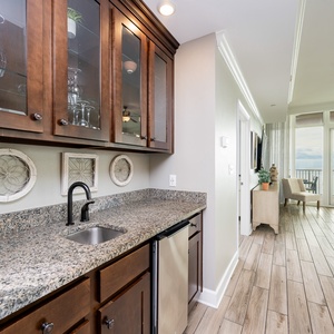 Grab a chilled drink from the fridge or create your favorite cocktail at the wet bar with elegant glassware displays