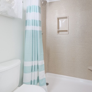 Relax in a refreshing shower with soothing water in the master bath after a day at the beach