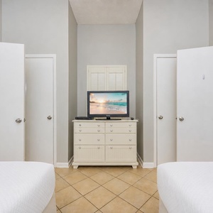Enjoy restful nights in this guest bedroom, with plush bedding and a TV ready for your favorite late-night shows