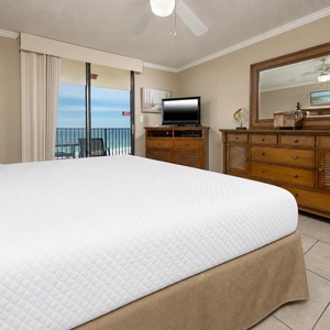 A king master suite offers quiet mornings and cozy nights with beach views through sliding glass doors