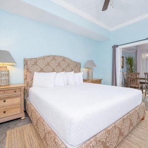 Relax in this inviting master suite featuring a plush king bed and a serene view through sliding glass doors