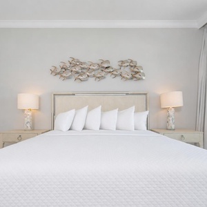 Rest in this serene master bedroom featuring a king bed, stylish decor, and soft lighting for a relaxing retreat