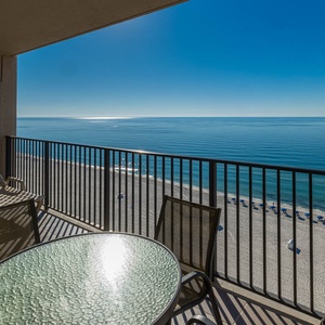 Savor your morning coffee at the table while enjoying expansive views of the tranquil beach from your balcony