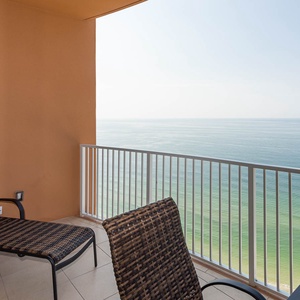 Gaze at the expansive coastline from the balcony seat as gentle waves roll along the shore below