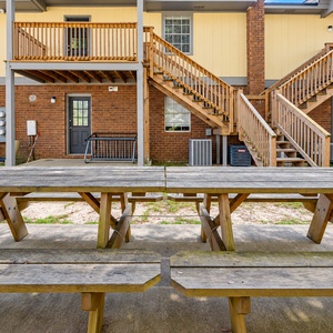 Relax in this spacious backyard with picnic tables and grills, perfect for gatherings and enjoying nature's beauty