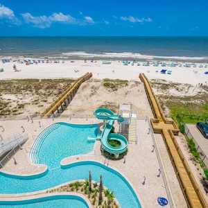 Relax on the balcony overlooking the pool area, refreshing lazy river, and adventurous waterslide