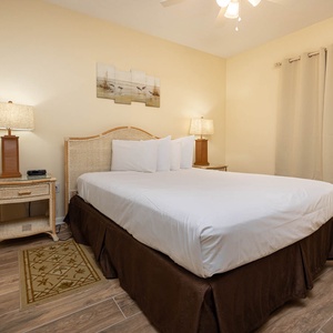 Relax in this inviting guest bedroom featuring a comfortable queen bed, stylish decor, and warm lighting for a restful stay