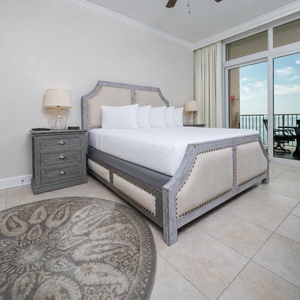 Sleep soundly in this inviting master bedroom featuring a king bed, stylish decor, and beachfront balcony access