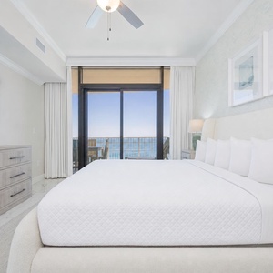 Experience restful nights in this serene master featuring a king bed and the sights and sounds of the coast
