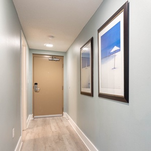 Welcoming entryway with coastal decor a light flooring, inviting guests to enjoy this beachfront vacation rental