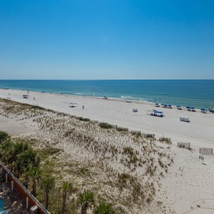 Enjoy the refreshing view from your balcony, overlooking the beach and inviting waters, perfect for relaxation