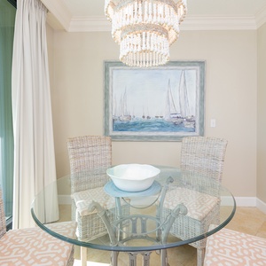 Enjoy leisurely afternoons at the glass dining table, with sun streaming through windows and coastal bay views