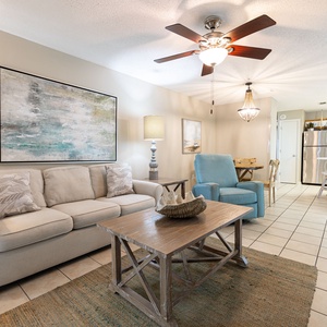 Unwind in the cozy living area, featuring a comfortable sofa, stylish decor, and a charming dining space