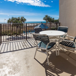 Savor the fresh air on the balcony offering views of the pool area and beach just steps away