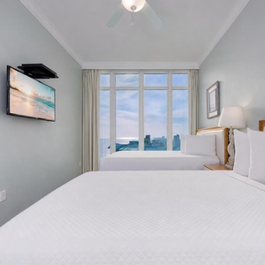 In the guest suite with two queen beds, you settle in to watch relaxing shows after a day exploring nearby coastlines