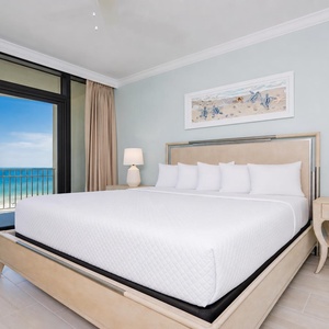 Spacious master suite featuring a large king bed and beautiful views through sliding glass doors