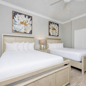 Relax in this guest suite with two cozy queen beds, adorned with fluffy pillows and stylish decor