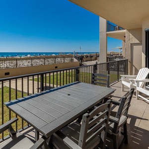 Dine al fresco at the spacious table while enjoying the refreshing breeze and views of the beach just steps away