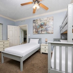 Cozy bunk room with a double bed under a twin bunk and additional comfy twin