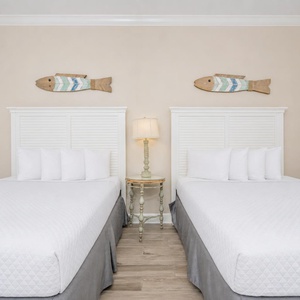 Feel the comfort of soft queen bedding in this cozy guest room, inviting you to recharge for another day on the beach