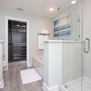 Soak in the jetted tub beneath coastal art or enjoy a refreshing shower after a day at the beach