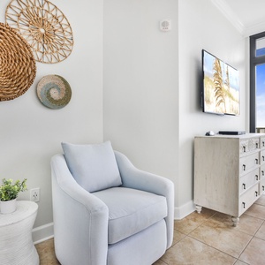 This seating area in the master features a light blue chair, decorative wall baskets, perfect for relaxation with a view