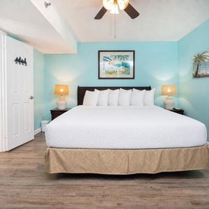 Soft lamps glow in your king master suite where gentle coastal art calms your senses